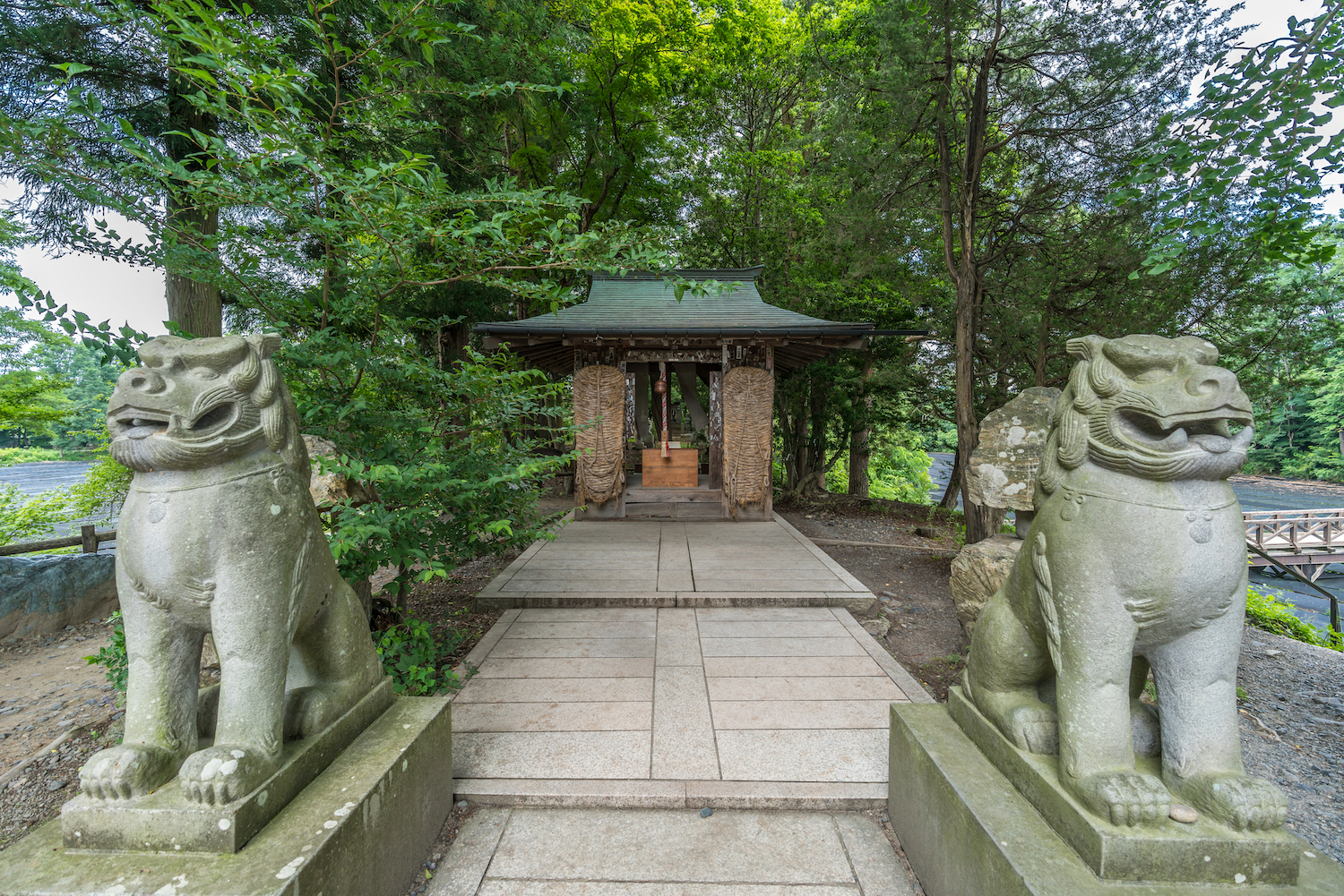 Azumino, Nagano Prefecture, Japan - August 2, 2017: Komainu Lion-Dog guardians at Daio Shrine. Located near Daio Wasabi Farm in Azumino, Nagano, Japan