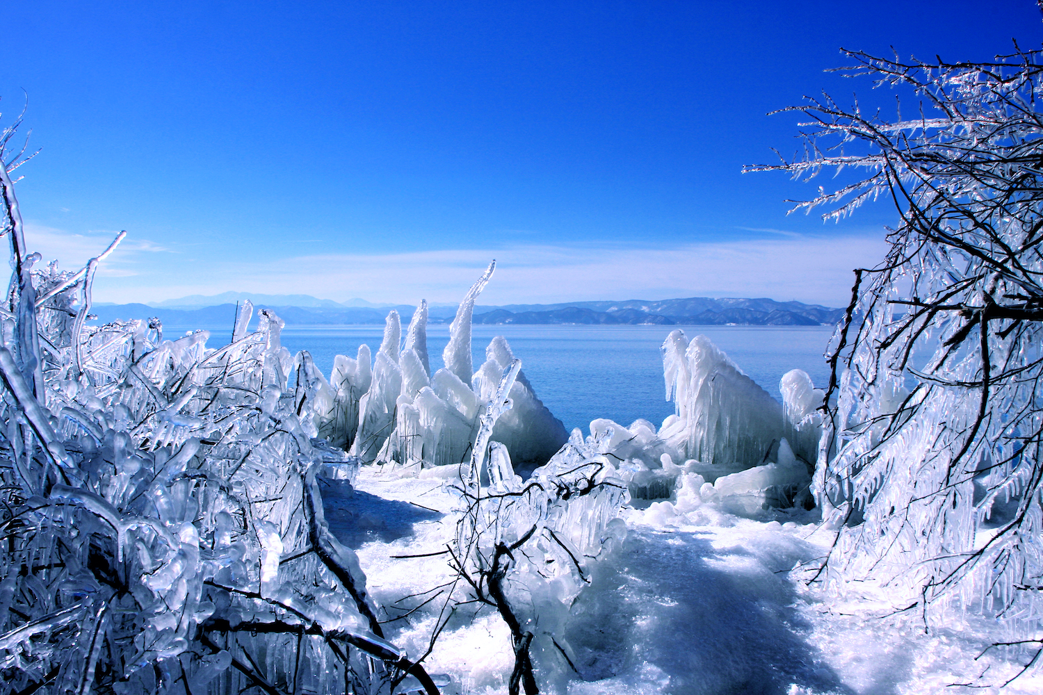 "It is Lake Inawashiro and Mount Bandai" beautiful winter scenery of Fukushima. Lake spray makes “shibuki-gori”, ice spray over the trees in winter