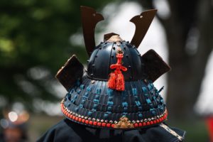 The samurai put a Japanese helmet
