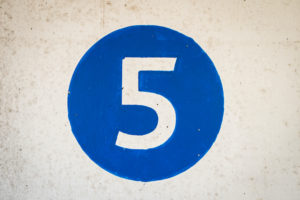 Number five in white in a blue circle