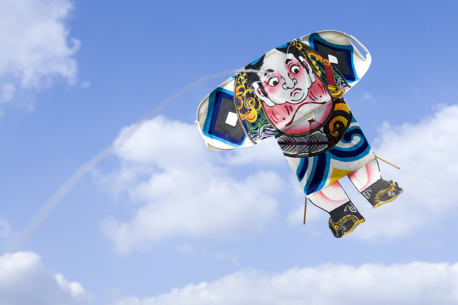 Japanese traditional kite flying over the blue sky