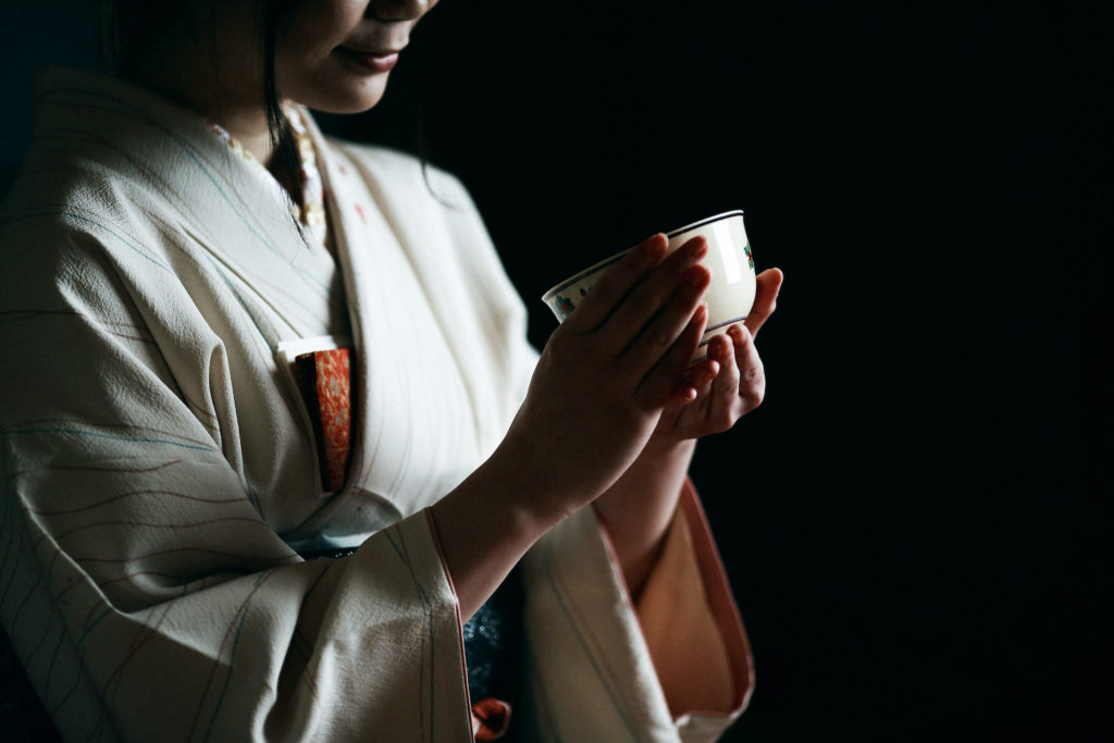 Japanese tea ceremony, a woman in kimono holding a tea cup