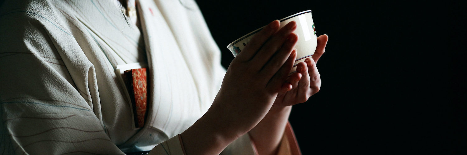 Japanese tea ceremony, a woman in kimono holding a tea cup