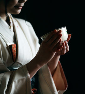 Japanese tea ceremony, a woman in kimono holding a tea cup