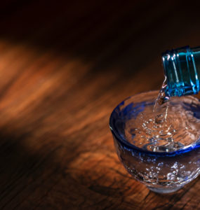 Pour sake into a transparent sake set