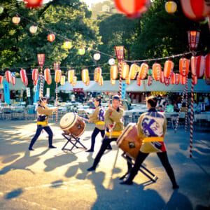 TOKYO, JAPAN - AUGUST 10 2012: Taiko drum performers from the Tsukiji Honganji Bon Odori Matsuri - the popular Bon Odori festival in Tokyo. Text on the lanterns are names of the festival sponsors.