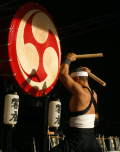 Traditional Japanese drummer with a large Japanese drum