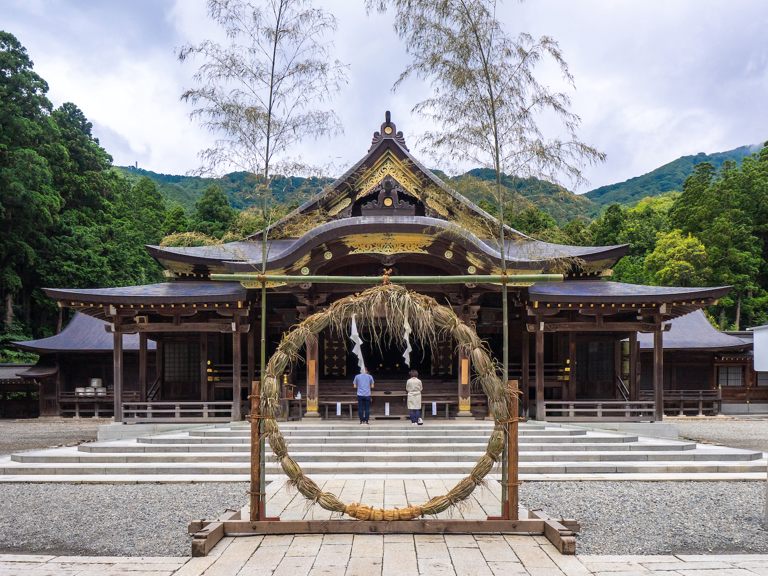 Main shrine and cogon grass ring (through which people pass as purification rite) (Yahiko shrine, Yahiko, Niigata, Japan)