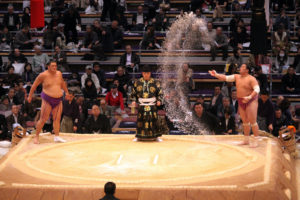 TOKYO - NOVEMBER 18: Sumo wrestler ceremonially throwing salt into the arena on November 18, 2010 in Fukuoka, Japan.