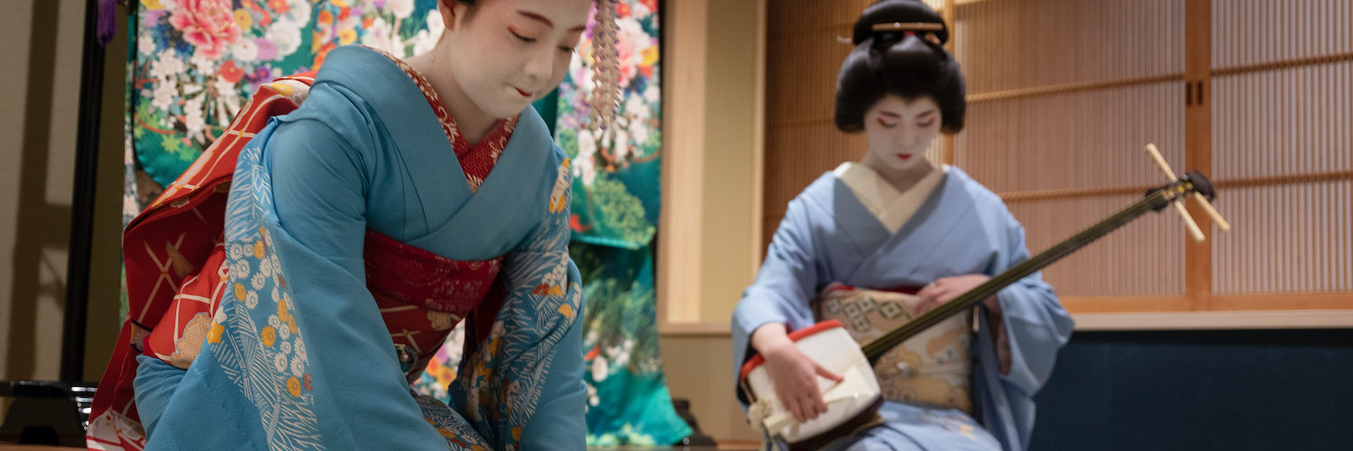Kyoto, Japan - May 19, 2019: Maiko bows at the end of traditional performance in a small Japanese inn with geisha behind