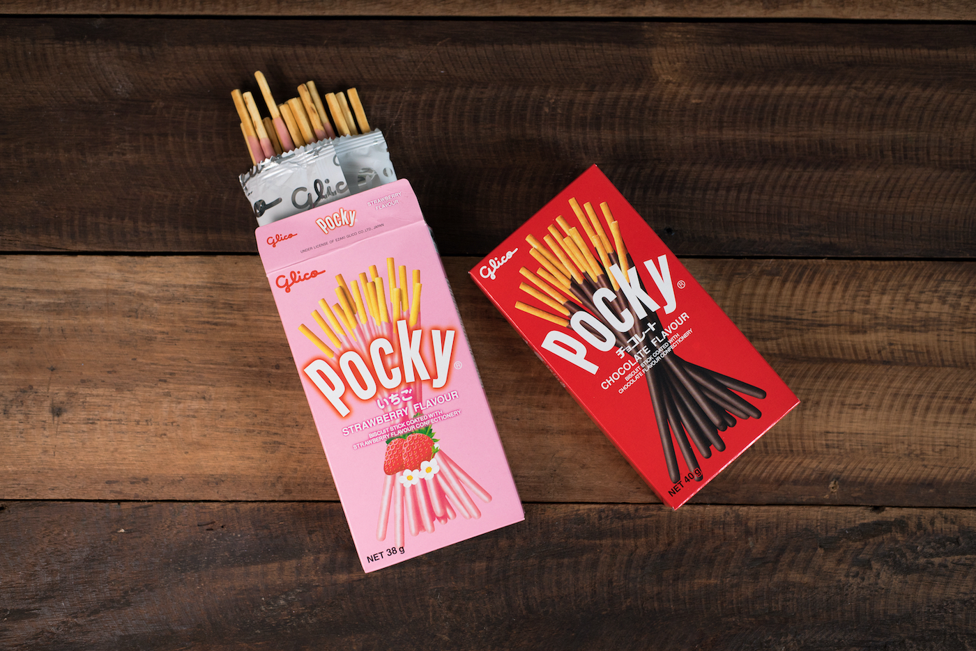 Pocky brand of chocolate sticks on wooden background. Pocky is a famous Japanese confectionery among Asian people