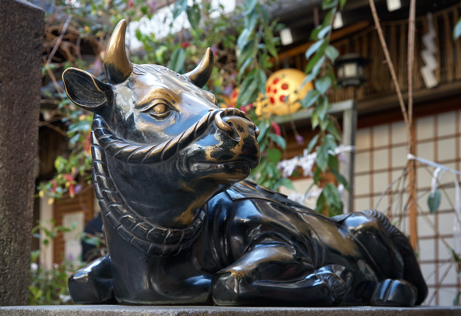 The metal statue of Temmangu Ox, the messengers of God of learning Tenjin (Sugawara no Michizane) at Nishiki-Tenmangu Shrine in the center of Nishiki Market, Kyoto, Japan