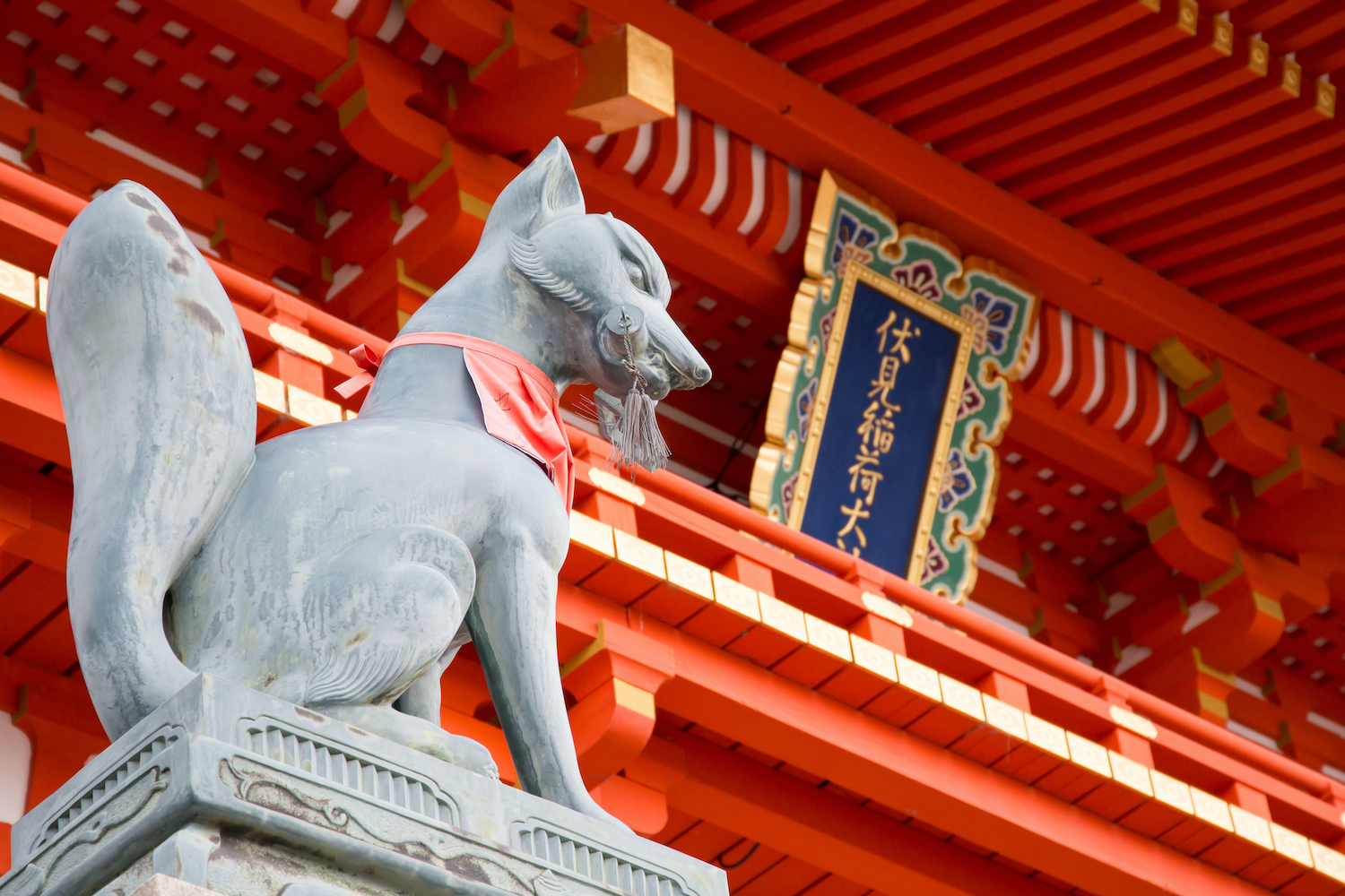 Fox statue at the main gate of Fushimi Inari shrine. The most famous attraction of Kyoto, Japan. Fox is a messenger between earth and heaven.