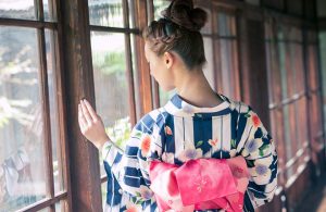 A woman's back in Yukata with pink Obi ribbon