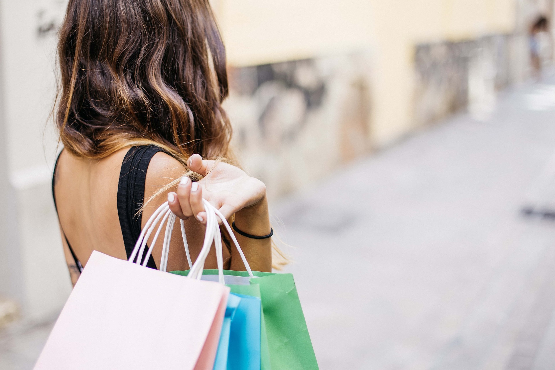 woman holding many shopping bags