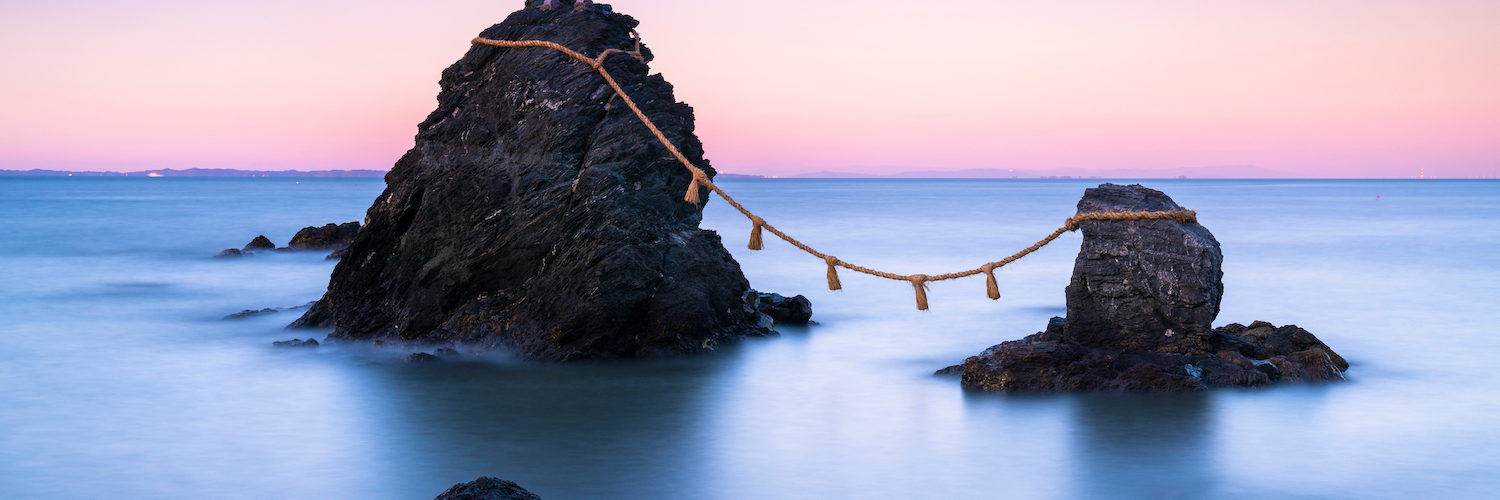 The wedded rocks (Meoto Iwa) in Ise, Japan on sunset. The larger of the two rocks represents the husband and the smaller one represents the wife.