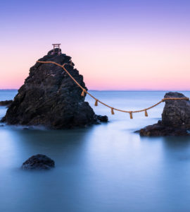 The wedded rocks (Meoto Iwa) in Ise, Japan on sunset. The larger of the two rocks represents the husband and the smaller one represents the wife.