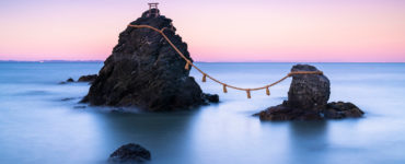 The wedded rocks (Meoto Iwa) in Ise, Japan on sunset. The larger of the two rocks represents the husband and the smaller one represents the wife.