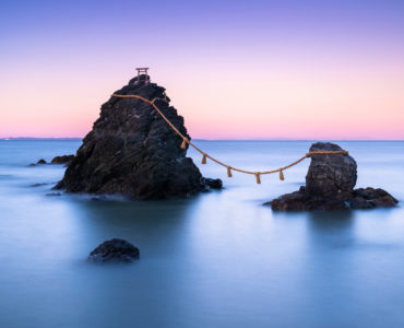 The wedded rocks (Meoto Iwa) in Ise, Japan on sunset. The larger of the two rocks represents the husband and the smaller one represents the wife.
