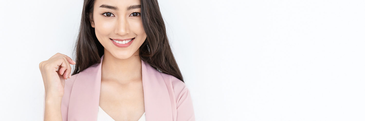 portrait of smiling confident woman in a pink jacket