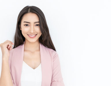 portrait of smiling confident woman in a pink jacket