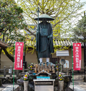 Kyoto, JAPAN - Apr 2 2021: The statue of Japanese Buddhist monk Kobo Daishi Kukai in To-ji (Toji Temple) complex on a sunny day. Translation: Namu-daishi-henjou-kongo (convert to Henjou-kongo Daishi)