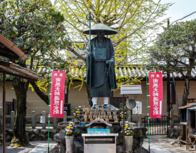 Kyoto, JAPAN - Apr 2 2021: The statue of Japanese Buddhist monk Kobo Daishi Kukai in To-ji (Toji Temple) complex on a sunny day. Translation: Namu-daishi-henjou-kongo (convert to Henjou-kongo Daishi)